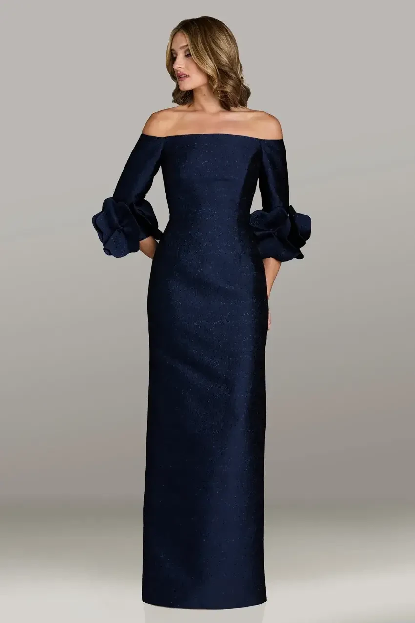 model is wearing a navy blue off the shoulder fit and flare evening gown