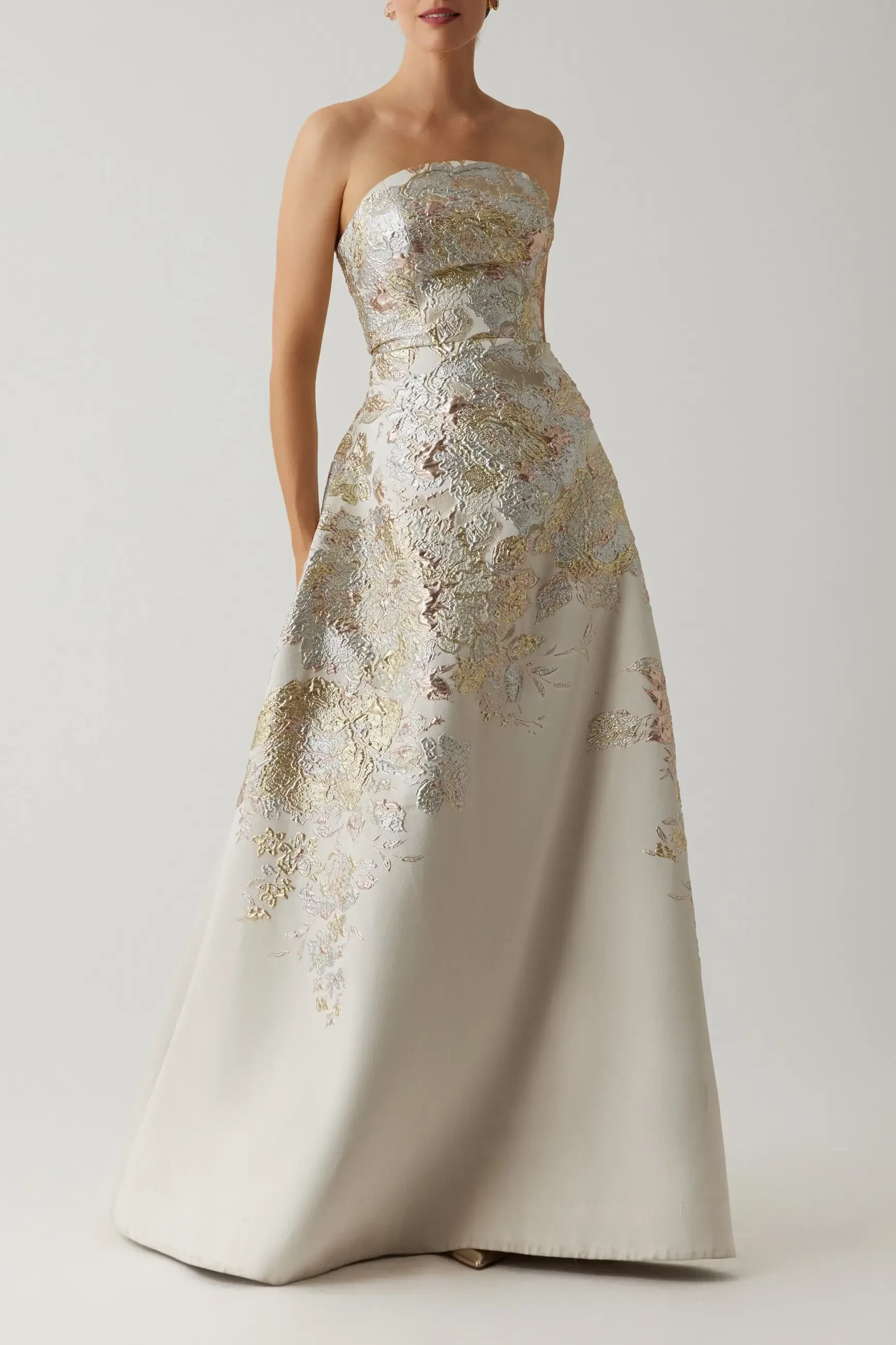 model is wearing a strapless mother of the bride gold dress