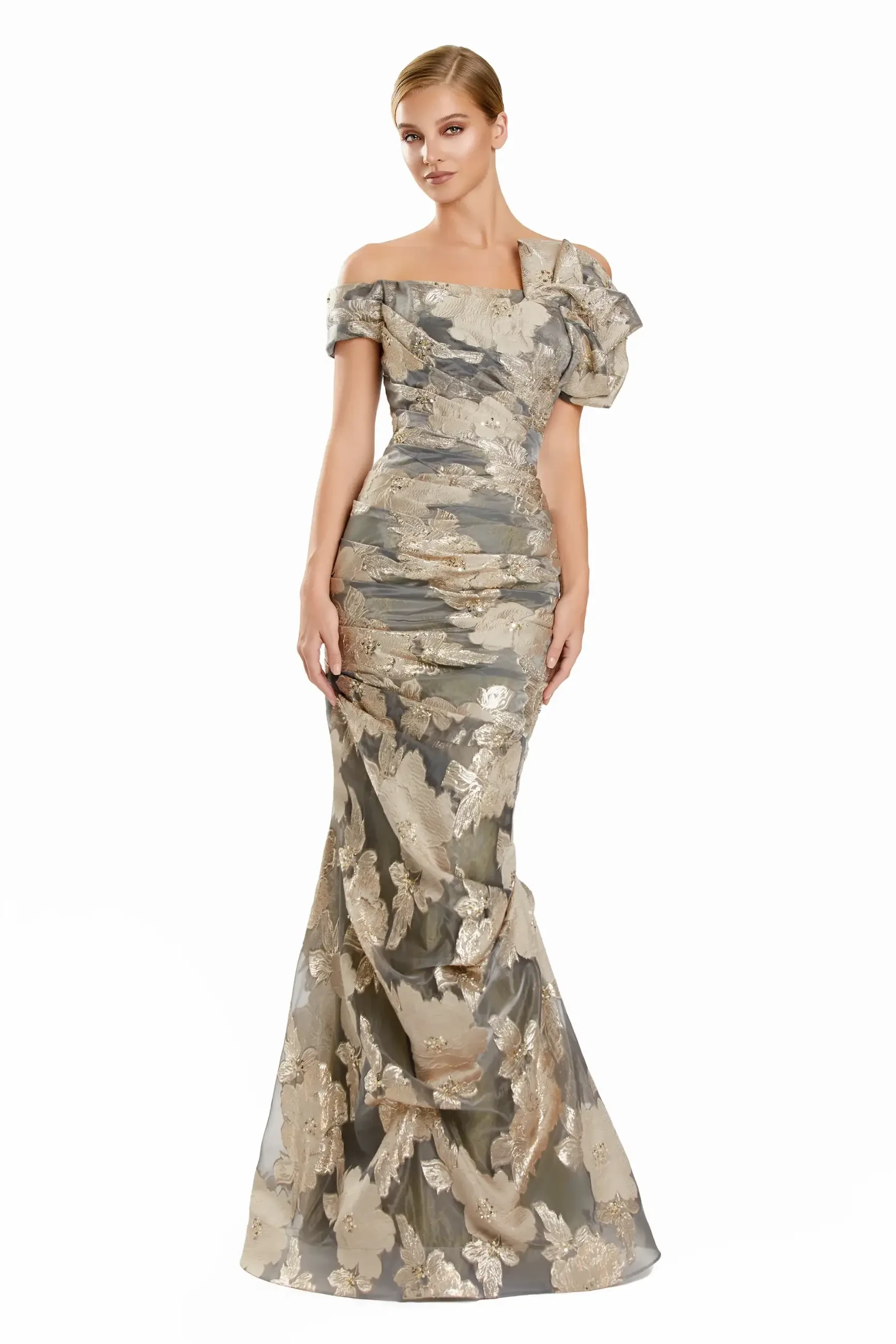 Woman in an elegant, off-shoulder gown with gold floral patterns on a metallic gray fabric, exuding a sophisticated and glamorous vibe.