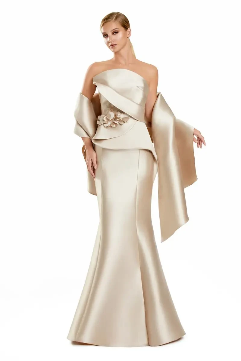 model is wearing a gold strapless floor length evening gown