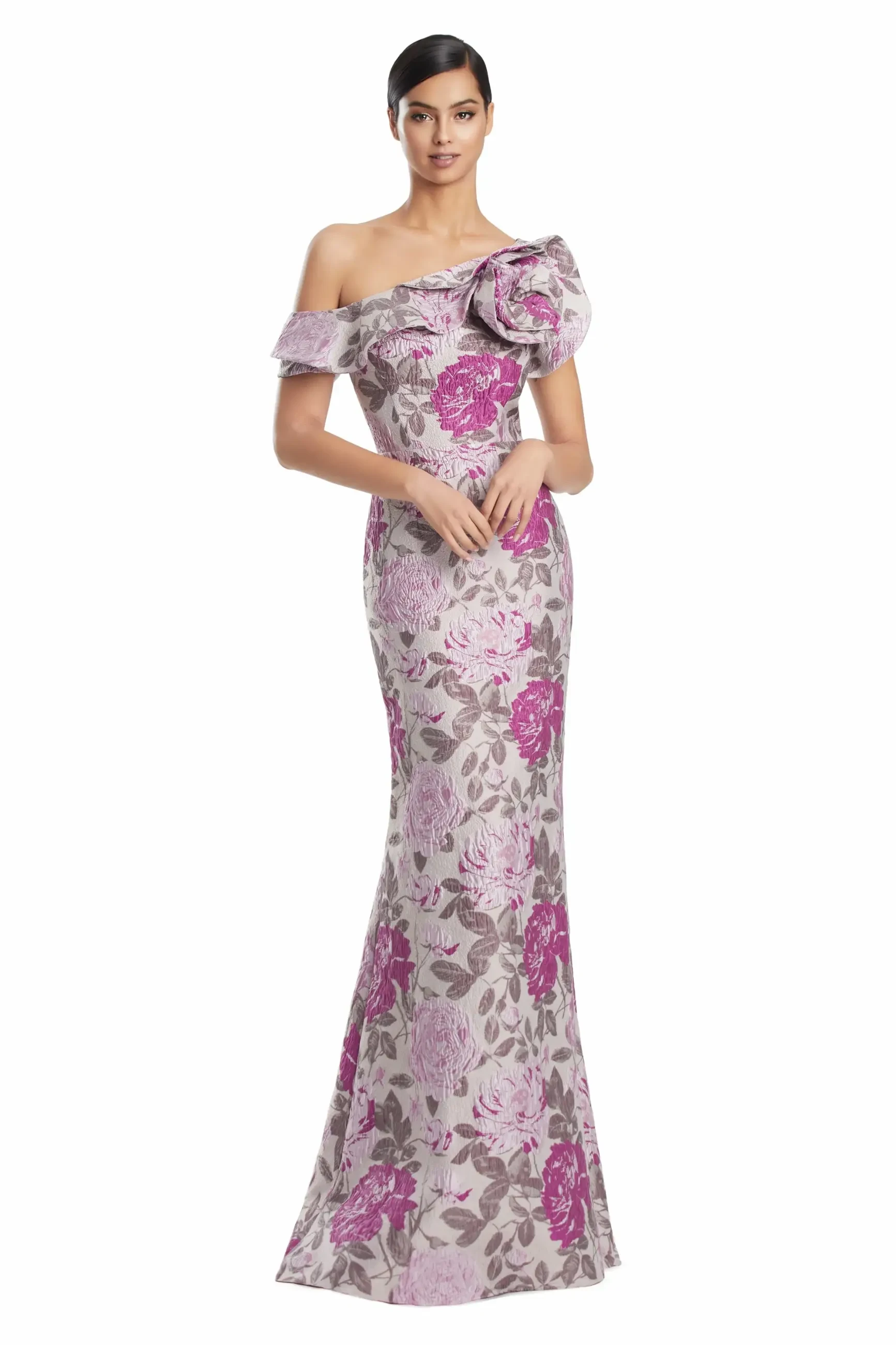 Woman in elegant floral gown with off-shoulder design, adorned with large pink and purple flowers. She stands gracefully, exuding sophistication.
