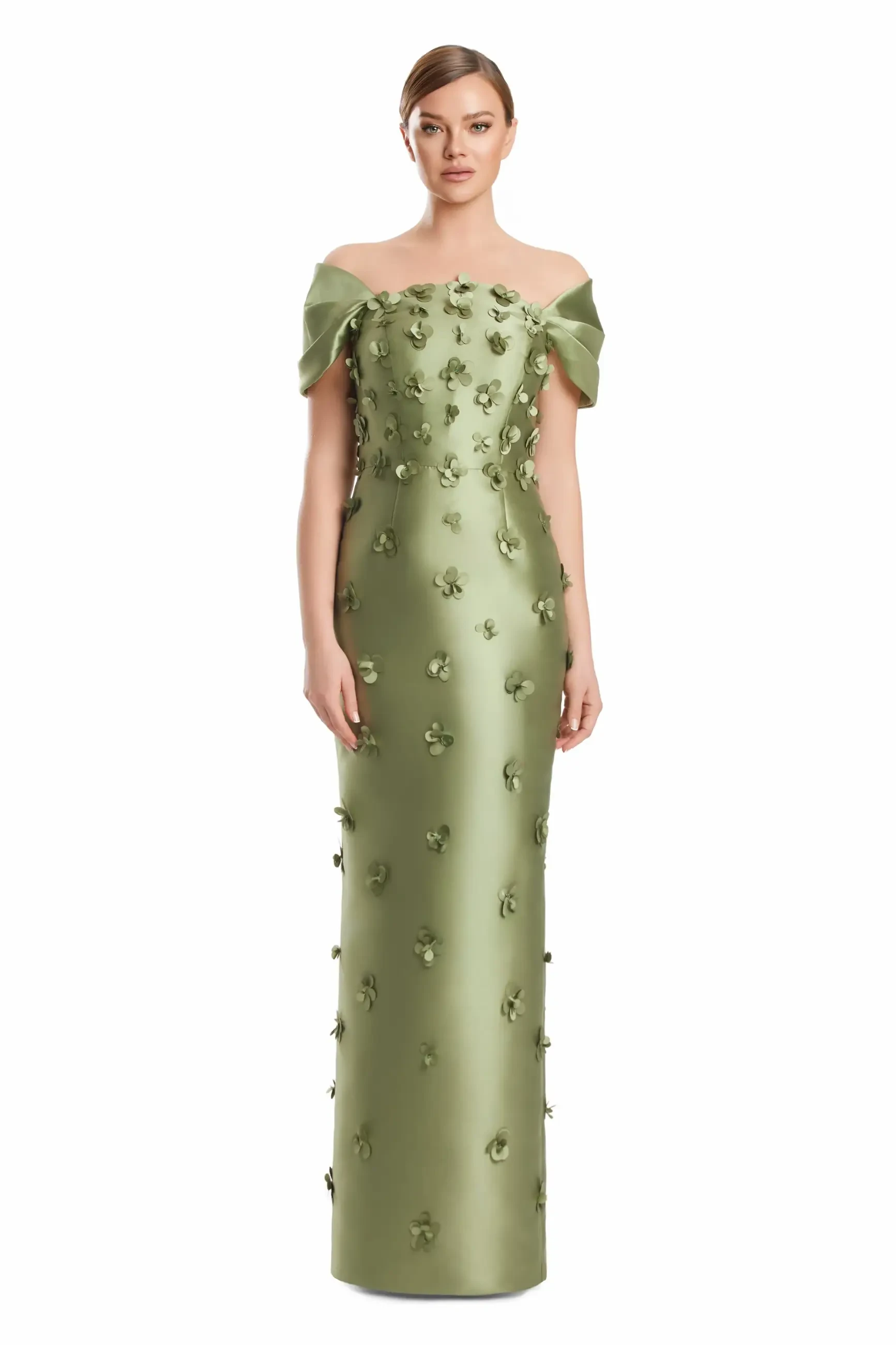 A woman in an elegant, off-shoulder, olive-green gown adorned with 3D floral accents stands against a white background, conveying a sophisticated and graceful tone.