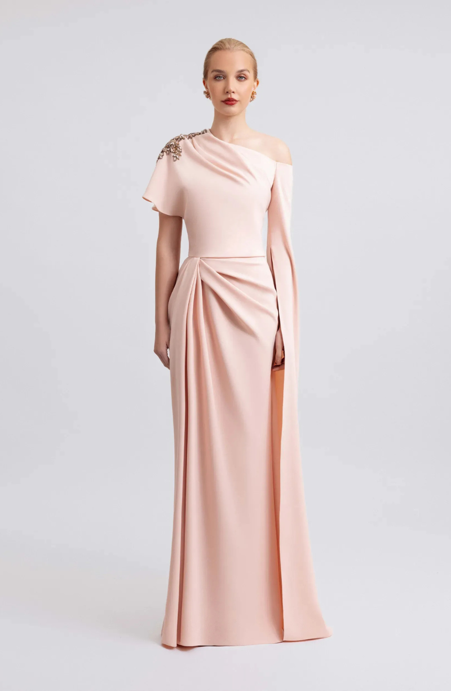 model is wearing a drapey light pink floor length evening gown