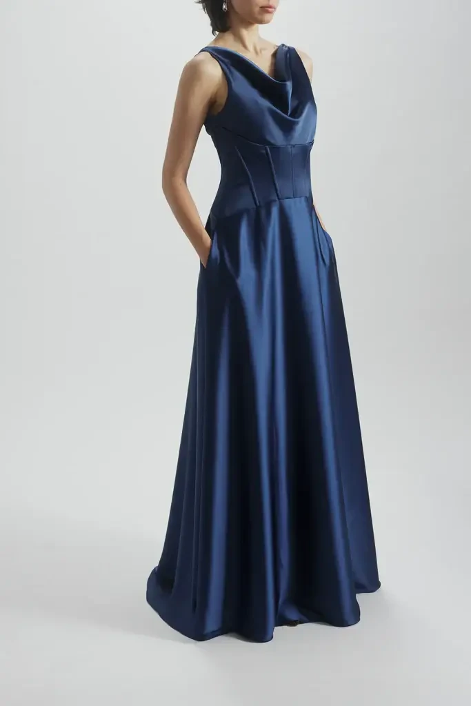 model is wearing a sleeveless cowl neck evening gown