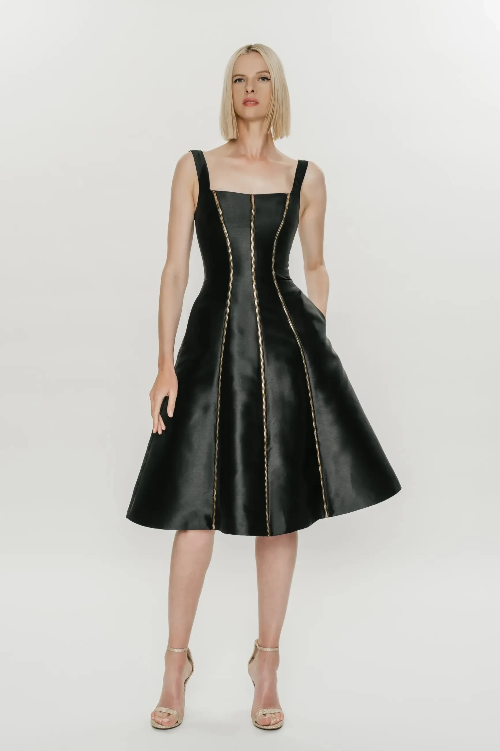model is wearing a knee length sleeveless black leather dress