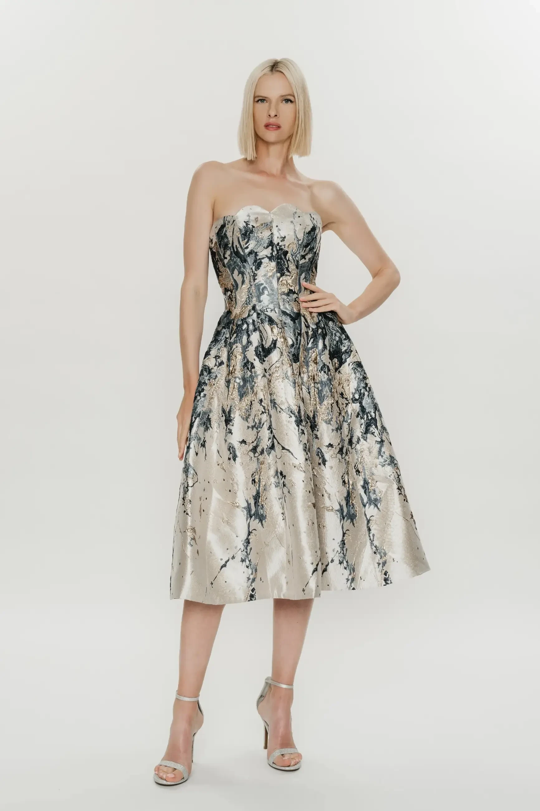model is wearing a strapless midi dress by hynes park