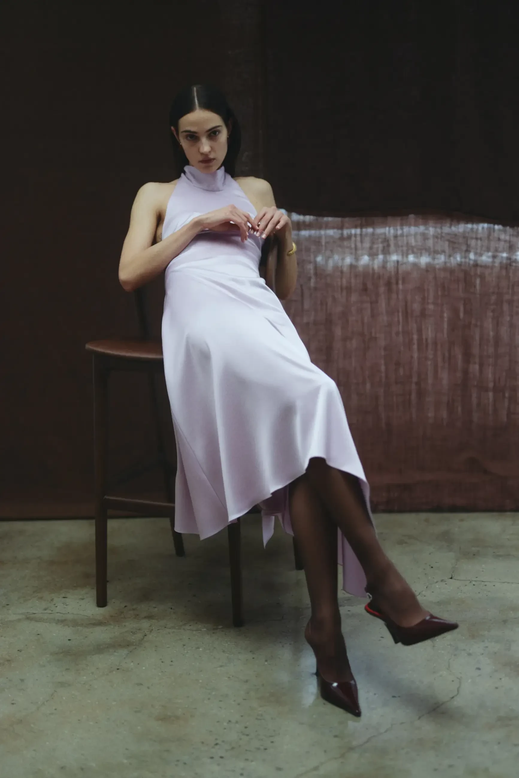 model is wearing a sleeveless purple amsale gown