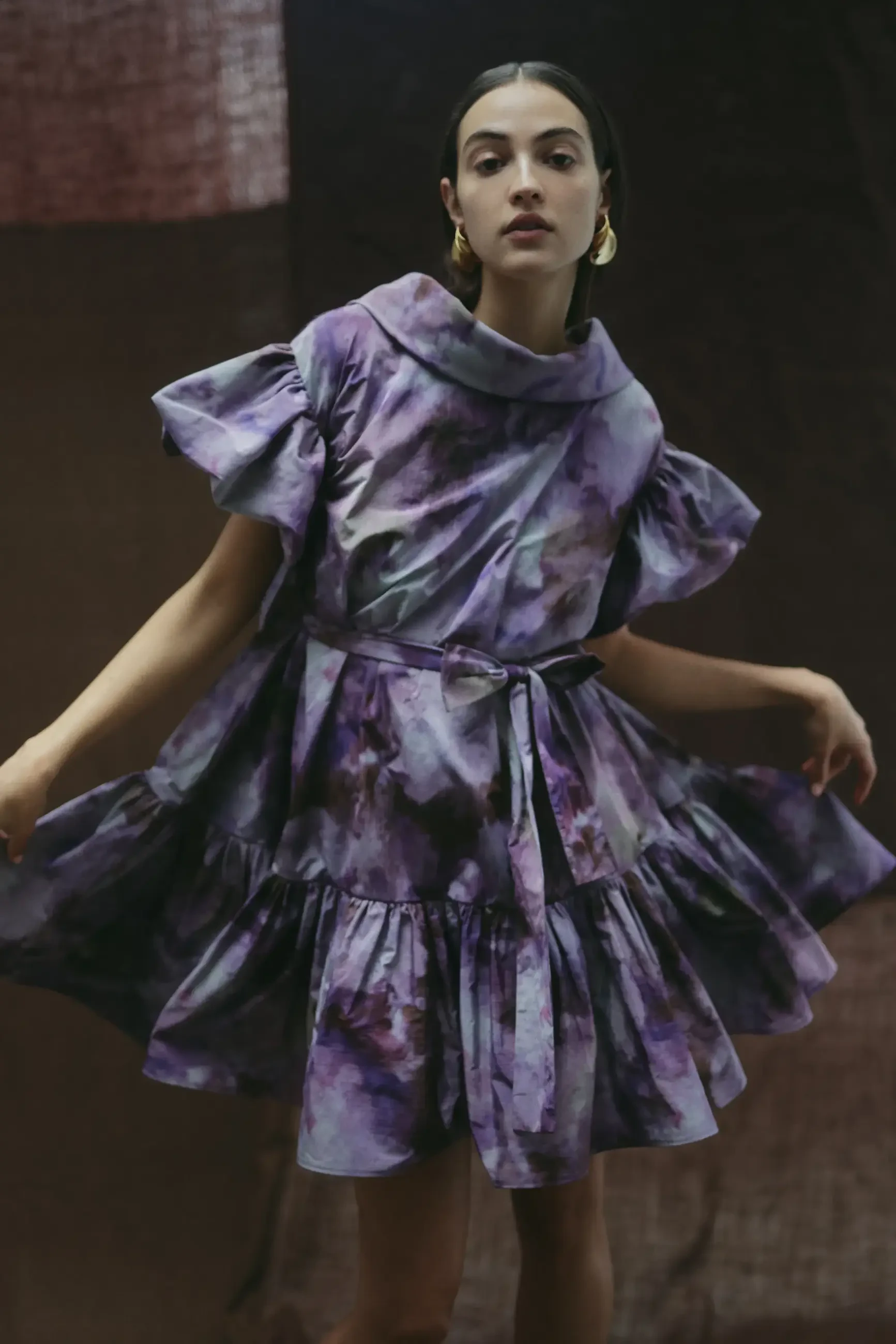 model is wearing a short purple evening gown by amsale