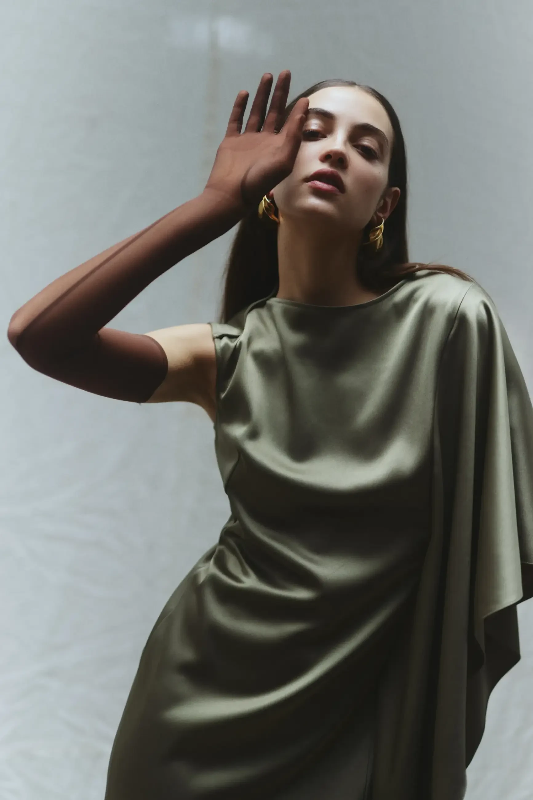 model is wearing a green one shoulder floor length dress